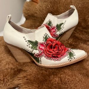 White leather boots with silver studs.